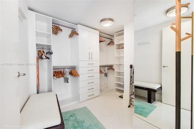 spacious closet with light tile patterned floors