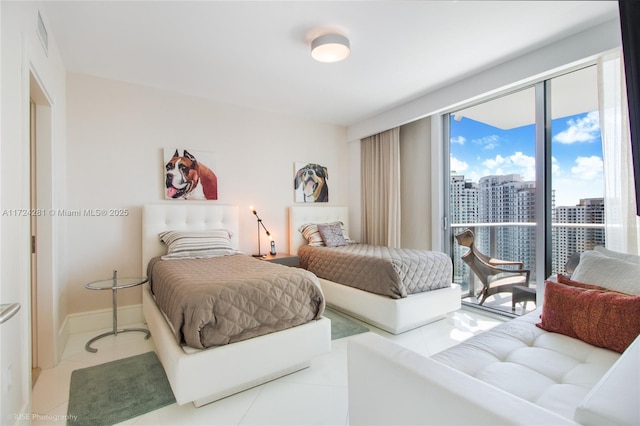 bedroom with access to exterior and light tile patterned floors