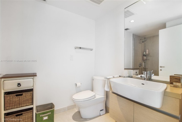 bathroom with vanity, toilet, and tile patterned flooring