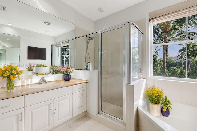 bathroom featuring walk in shower, tile patterned floors, and vanity