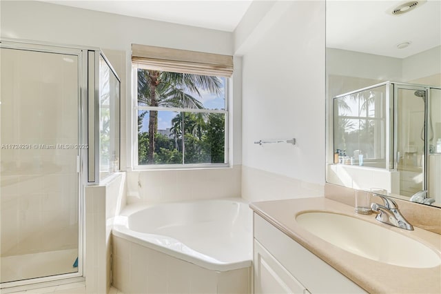 bathroom featuring vanity and separate shower and tub