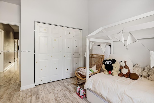 bedroom featuring a closet and light wood-type flooring