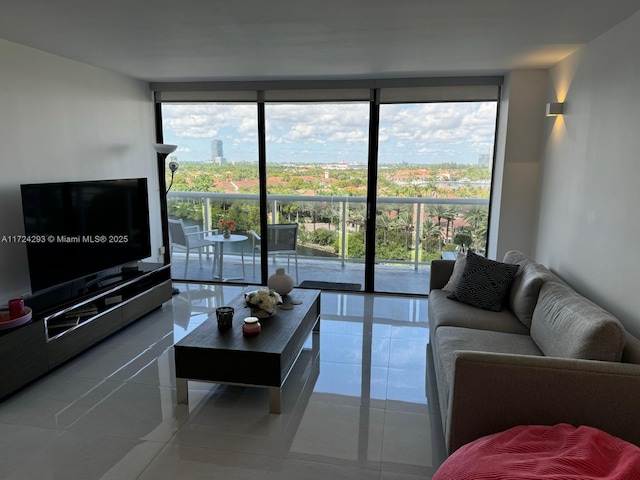 living room with floor to ceiling windows and tile patterned flooring