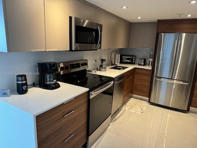 kitchen featuring dark brown cabinetry, sink, light tile patterned flooring, and stainless steel appliances