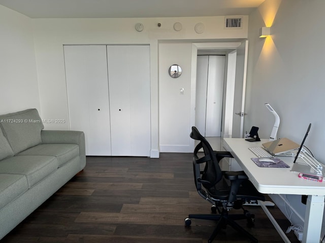 home office with dark hardwood / wood-style floors