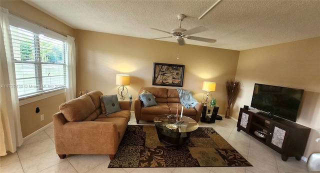 tiled living room featuring a textured ceiling and ceiling fan