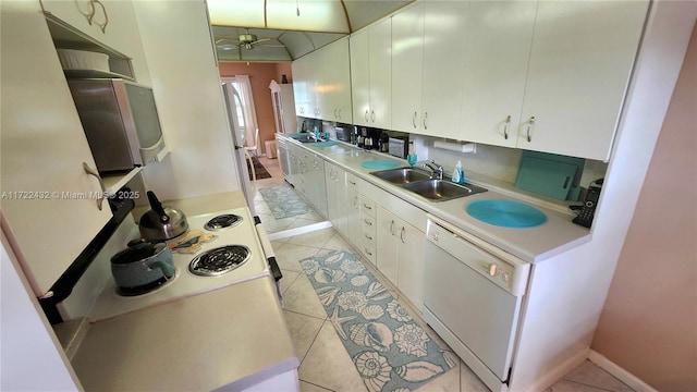 kitchen featuring sink, white cabinetry, dishwasher, and light tile patterned floors