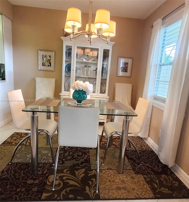 dining space with tile patterned flooring, a chandelier, and a healthy amount of sunlight