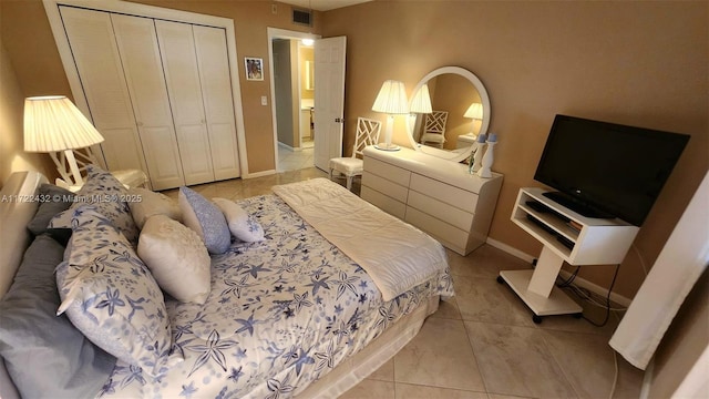 bedroom with a closet and light tile patterned floors