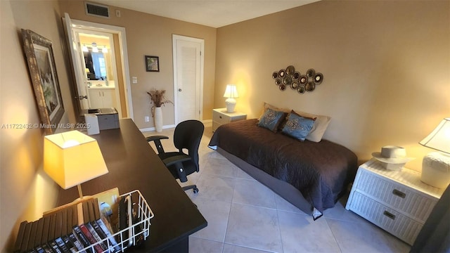 tiled bedroom featuring a closet and connected bathroom