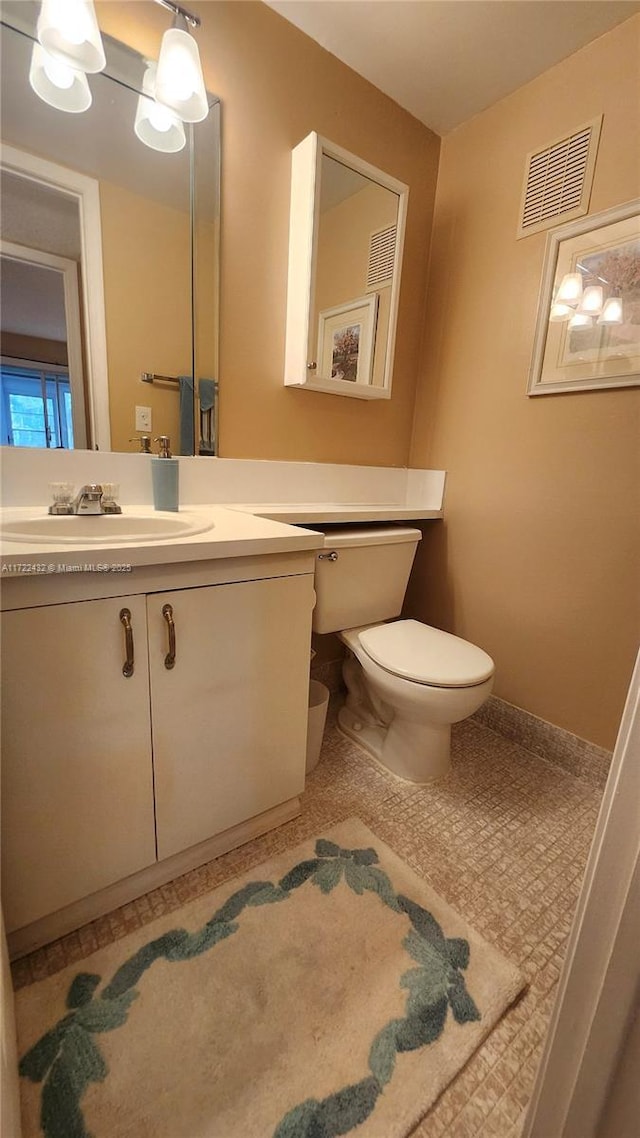 bathroom featuring toilet and vanity