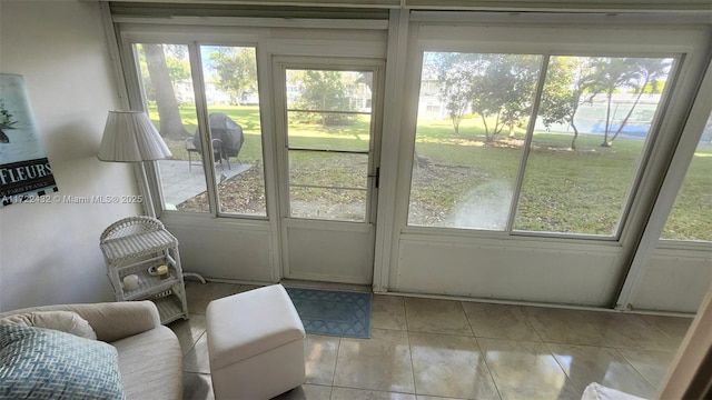 doorway featuring light tile patterned floors and a healthy amount of sunlight