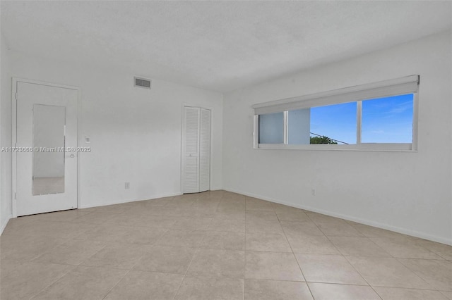 empty room featuring visible vents and baseboards