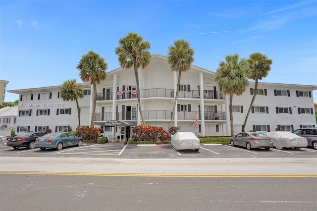 view of building exterior featuring uncovered parking