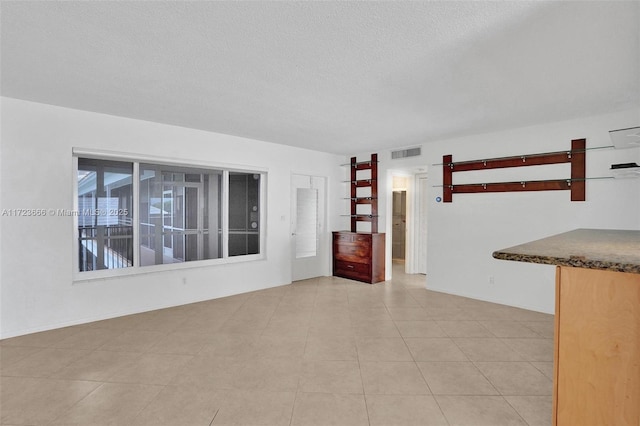 spare room with a textured ceiling and visible vents