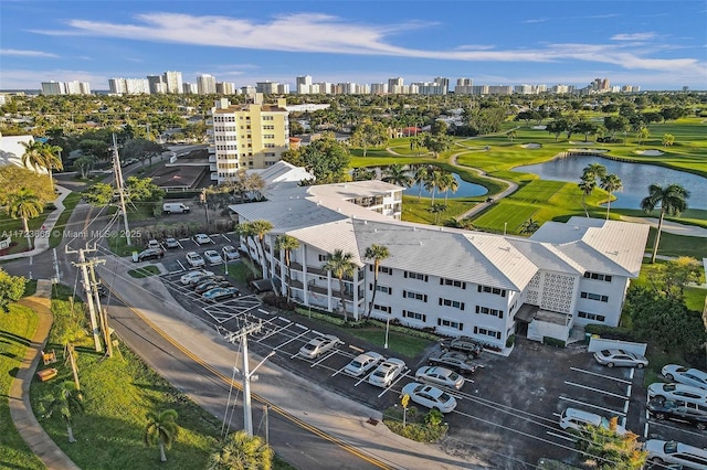 birds eye view of property featuring a water view, golf course view, and a city view