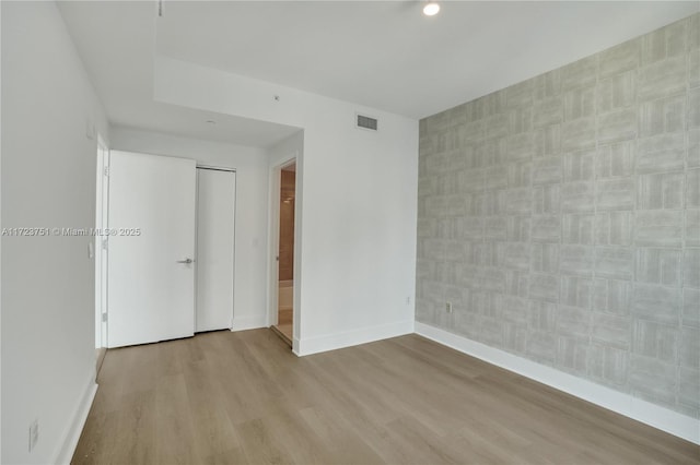 unfurnished room with light wood-type flooring