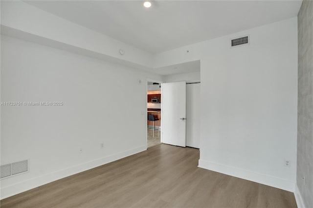 spare room with hardwood / wood-style flooring