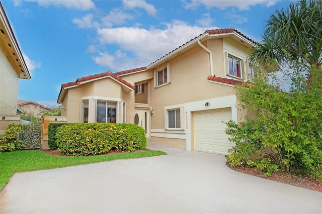 mediterranean / spanish-style house with a front yard