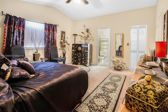 carpeted bedroom with lofted ceiling, ceiling fan, and connected bathroom