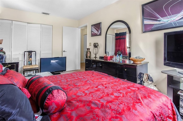 bedroom with a closet and visible vents