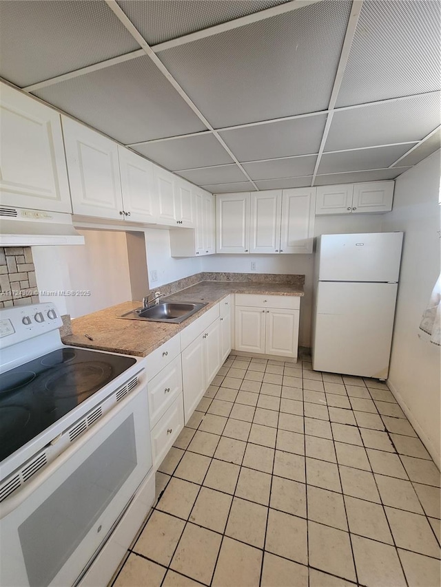 kitchen with sink, white cabinets, white appliances, and light tile patterned floors