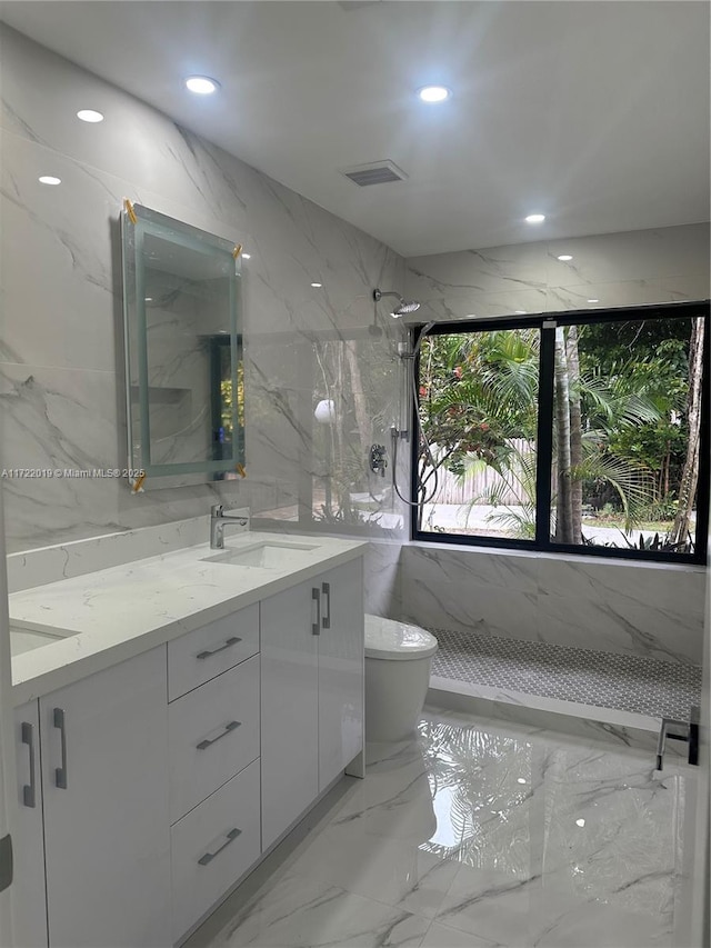 bathroom featuring vanity, tile walls, toilet, and walk in shower