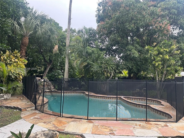 view of pool with an in ground hot tub and a patio area