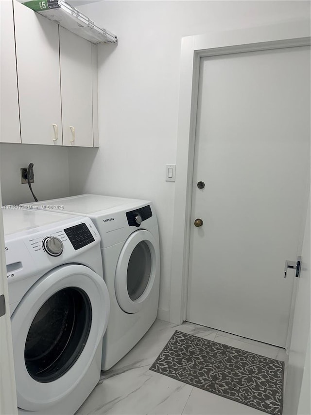 laundry room with cabinets and washer and dryer