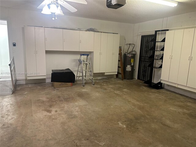 garage featuring ceiling fan, a garage door opener, and water heater