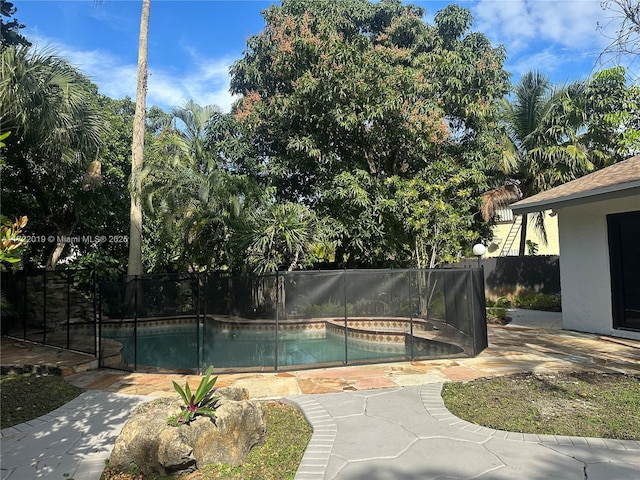 view of pool featuring a patio and a hot tub