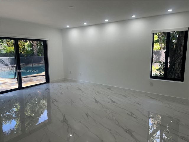 unfurnished room featuring a wealth of natural light