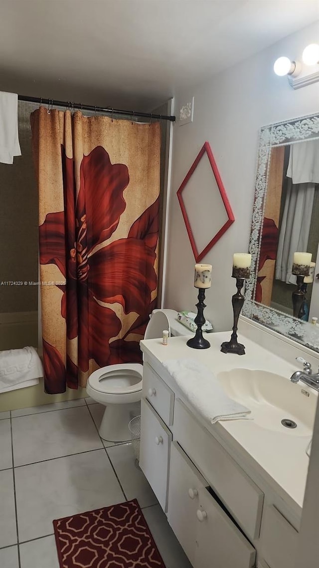 bathroom with tile patterned flooring, vanity, toilet, and curtained shower