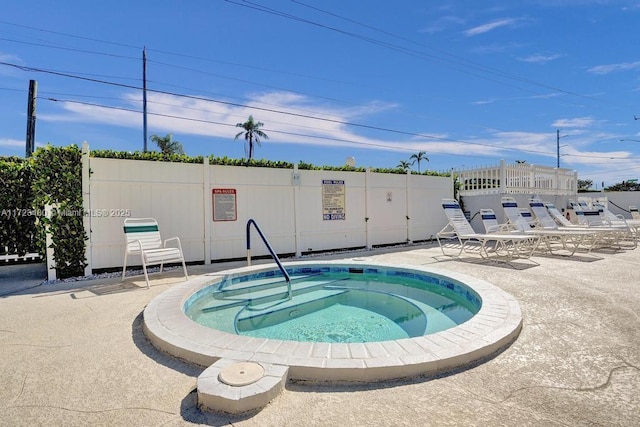 view of swimming pool with a patio area and a hot tub