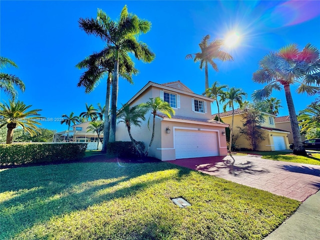 view of front of house with a front lawn and a garage