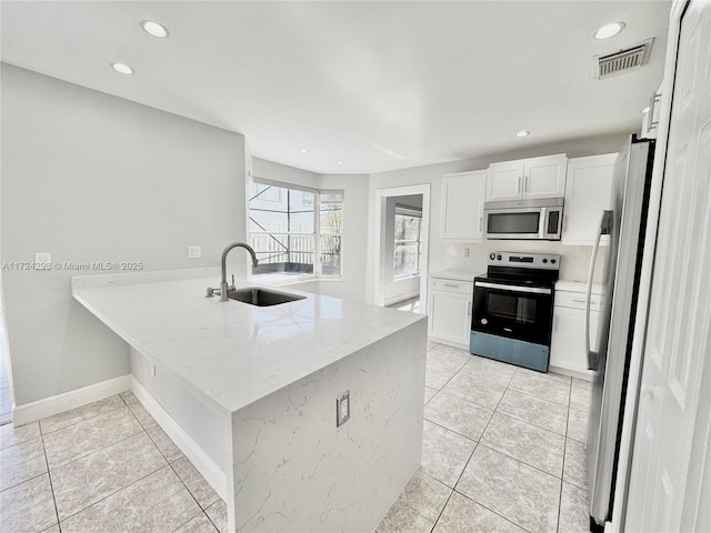 kitchen with kitchen peninsula, stainless steel appliances, white cabinetry, and sink