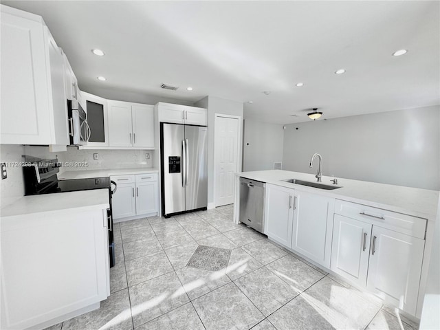 kitchen with ceiling fan, sink, white cabinetry, and stainless steel appliances