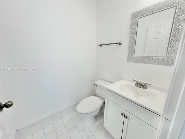 bathroom featuring toilet, vanity, and tile patterned floors