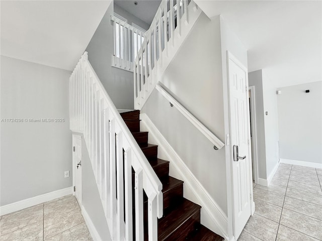 stairs featuring tile patterned flooring