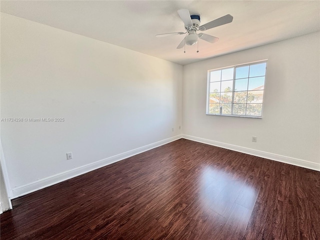 spare room with ceiling fan and dark wood-type flooring