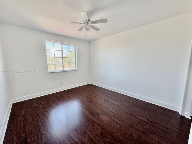 spare room with dark hardwood / wood-style flooring and ceiling fan