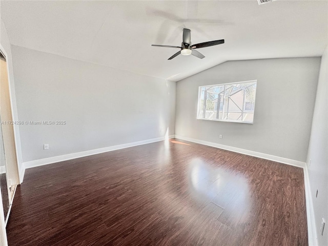 spare room with ceiling fan, dark hardwood / wood-style floors, and lofted ceiling