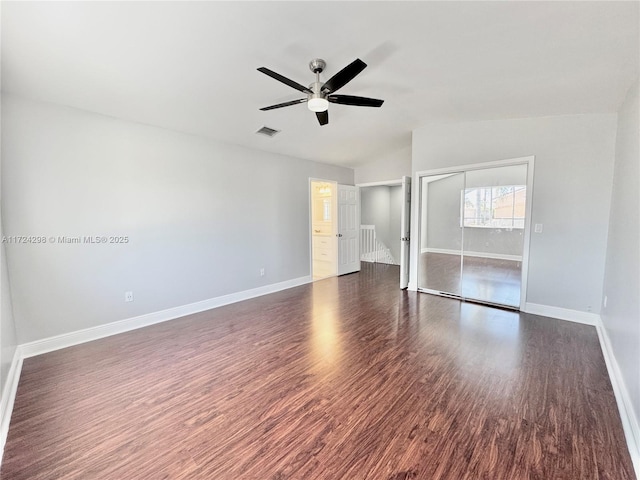 empty room with ceiling fan and dark wood-type flooring