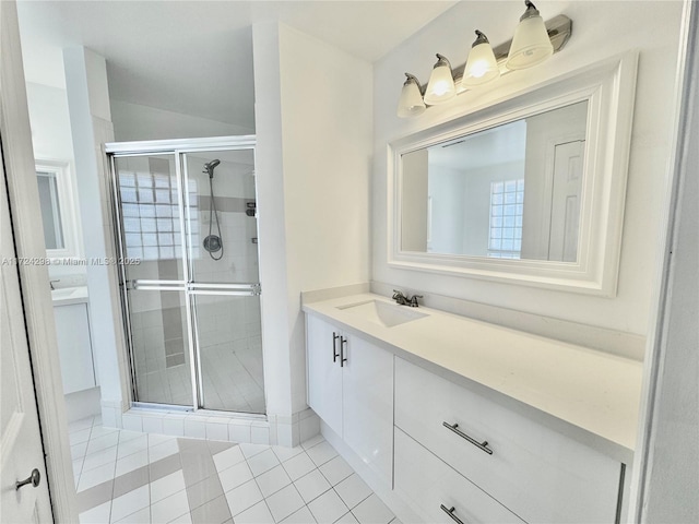 bathroom featuring tile patterned flooring, vanity, and an enclosed shower