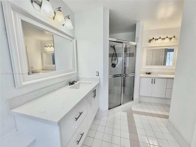 bathroom featuring tile patterned floors, vanity, and a shower with shower door