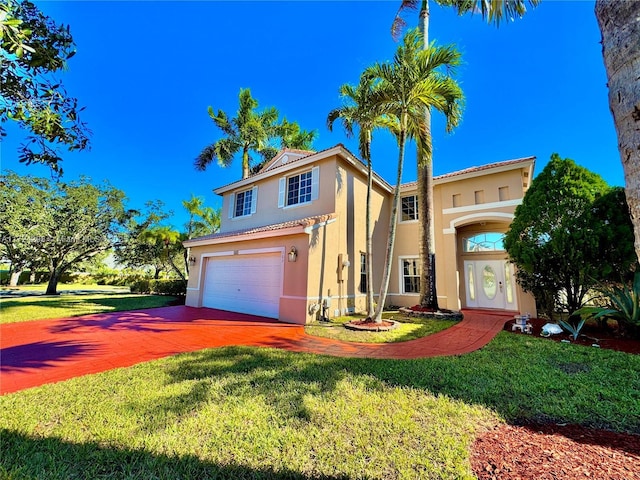 mediterranean / spanish-style home with a garage and a front lawn