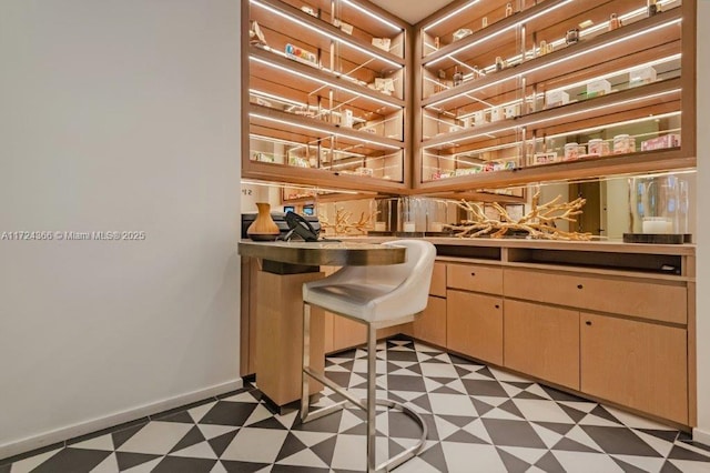 bar featuring light brown cabinetry