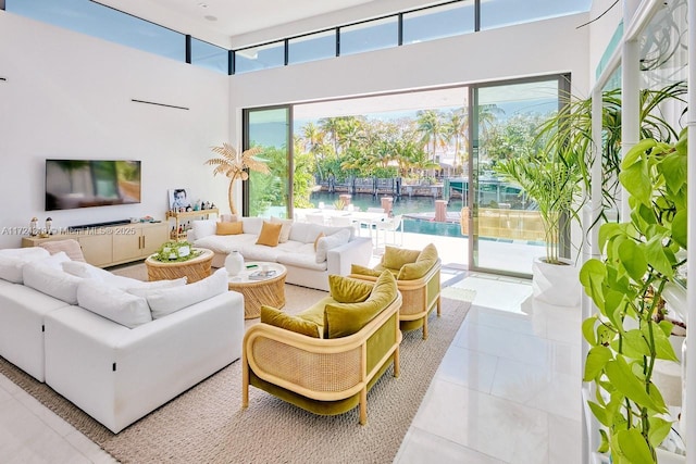 living room featuring tile patterned flooring and a water view