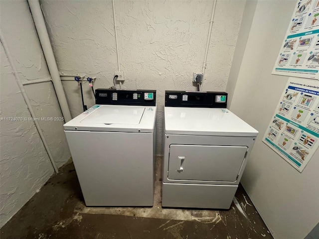 washroom with washing machine and clothes dryer