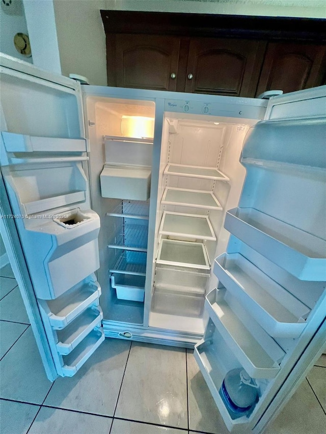 interior details featuring dark brown cabinets and refrigerator